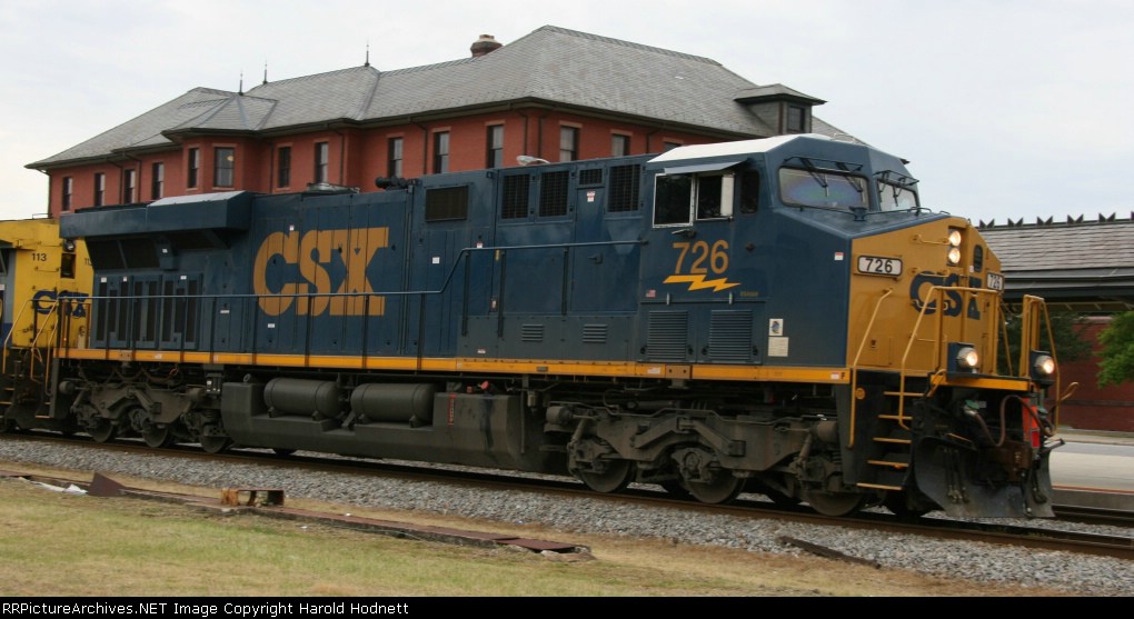 CSX 726 passes the station with a northbound train